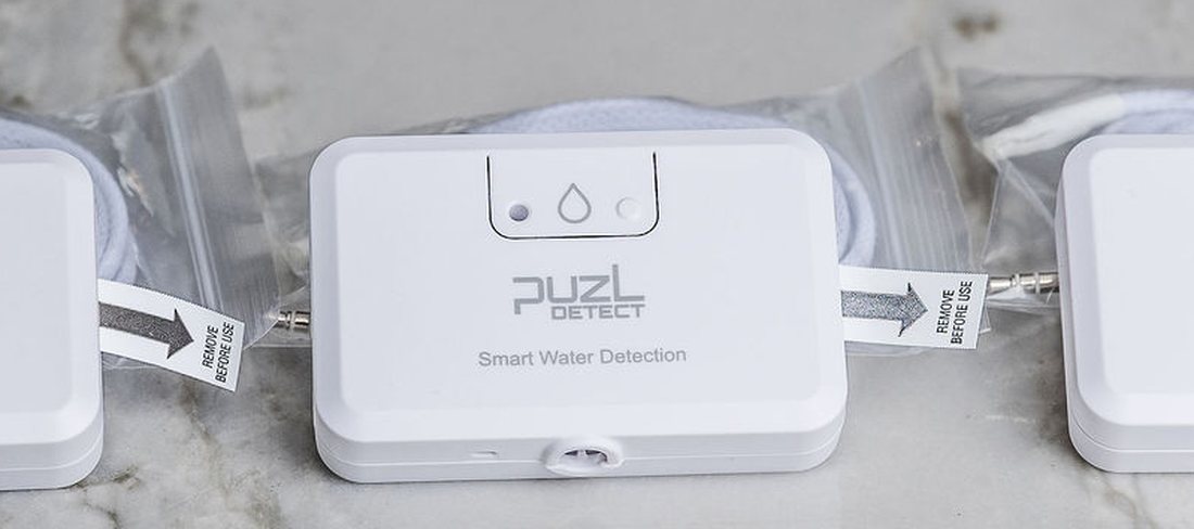 Close-up of a PuzL Detect unit, with two more units just visible at the edges