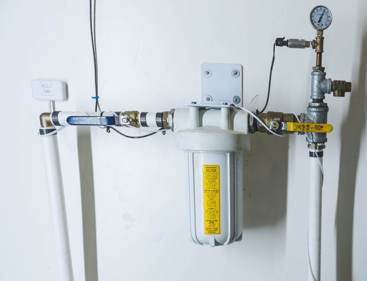 PuzL sensing cable threaded along the pipe, around a whole-house filter and shut-off valve