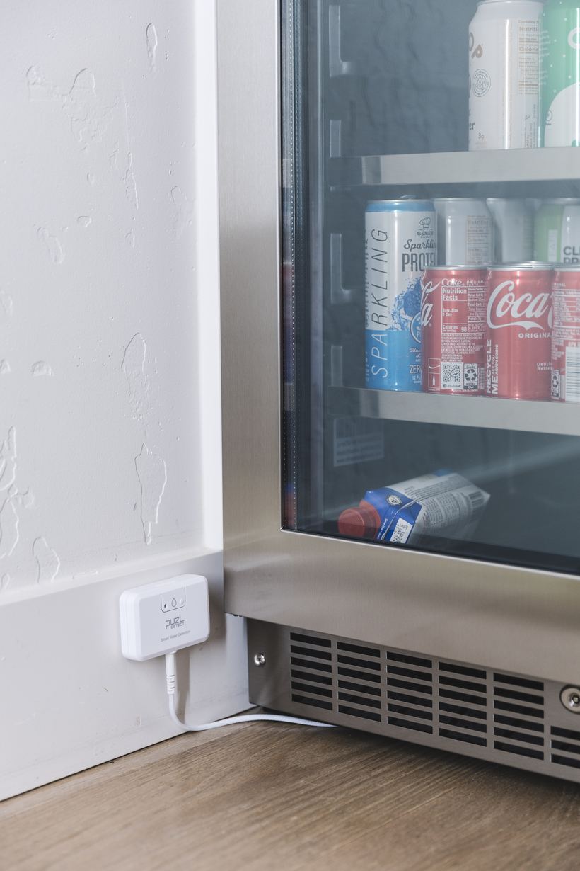 PuzL Detect beside a beverage refrigerator with the cable along the floor