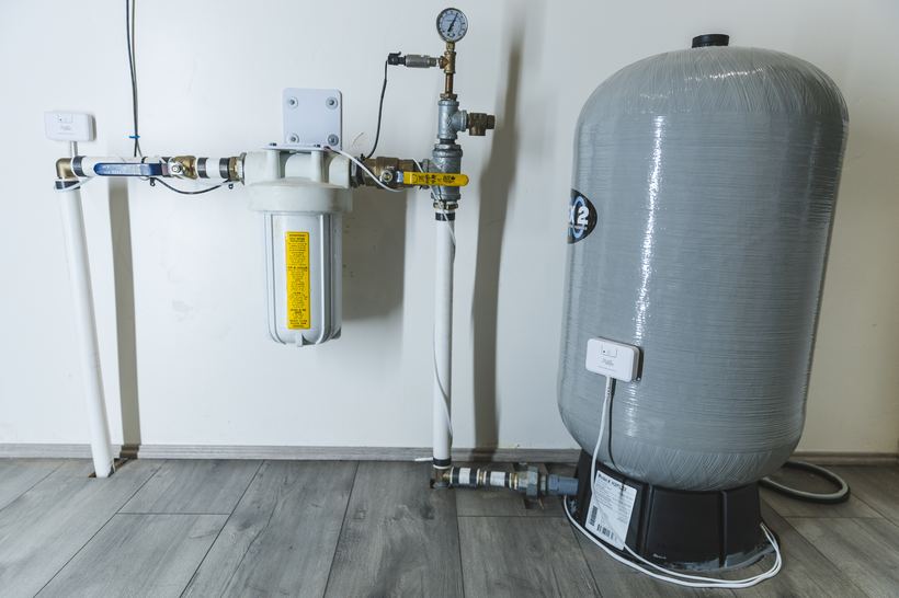 PuzL sensing cable threaded around a whole-house water filter and valve